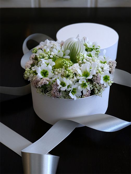 白い花を集めて初夏のボックスフラワーを贈り花に。ライラック、リューココリーネ‘緑のリューコ’、スターチス‘レディスノー’をベースに、パフィオペディルムをアクセントに加えて。白花のライスフラワーがボックスのすき間をきれいに埋めてくれます。