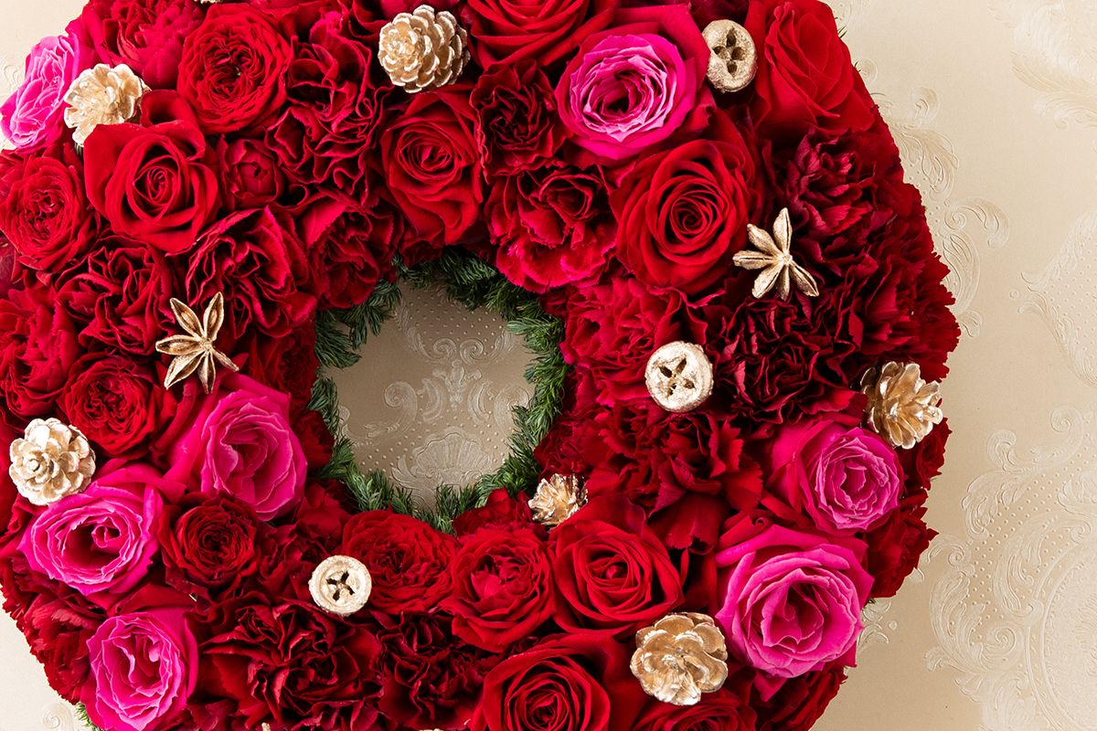 クリスマスの華やかさと煌めきを──バラとカーネーションによる深紅のリース