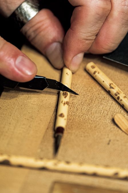 筆を使いやすい長さにカットする様子に、「道具を扱う指先にも、熟練の職人の息遣いが感じられますね」と藤間さん。